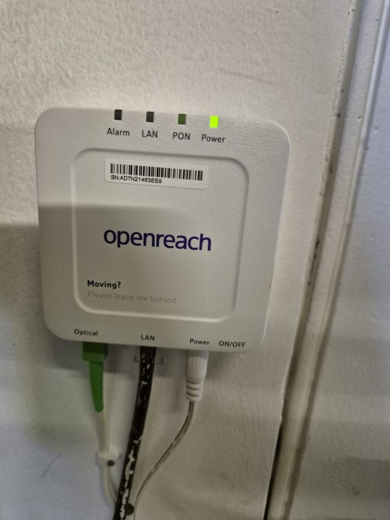 An Optical Network Terminal ONT device in a modern home setup, highlighting its role in converting fibre optic signals into electrical signals for high-speed internet and seamless connectivity.