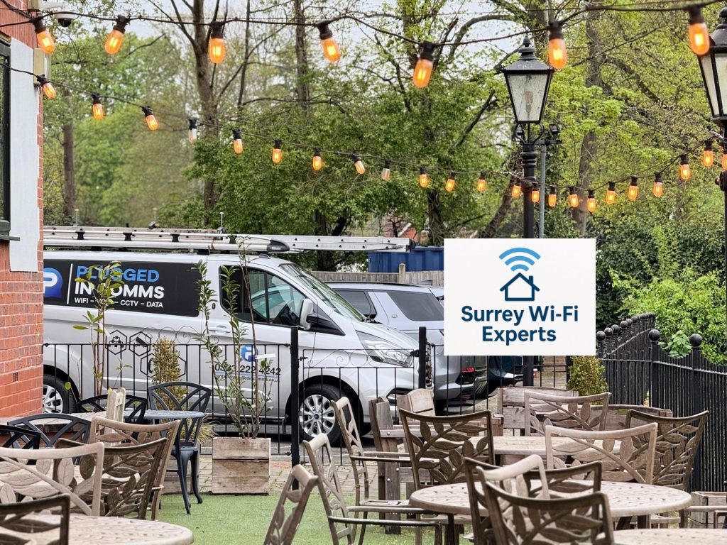 Surrey Wi-Fi & VoIP Experts van parked outside The Bridge Hotel in Chertsey, Surrey, beside the River Thames during a local service visit.