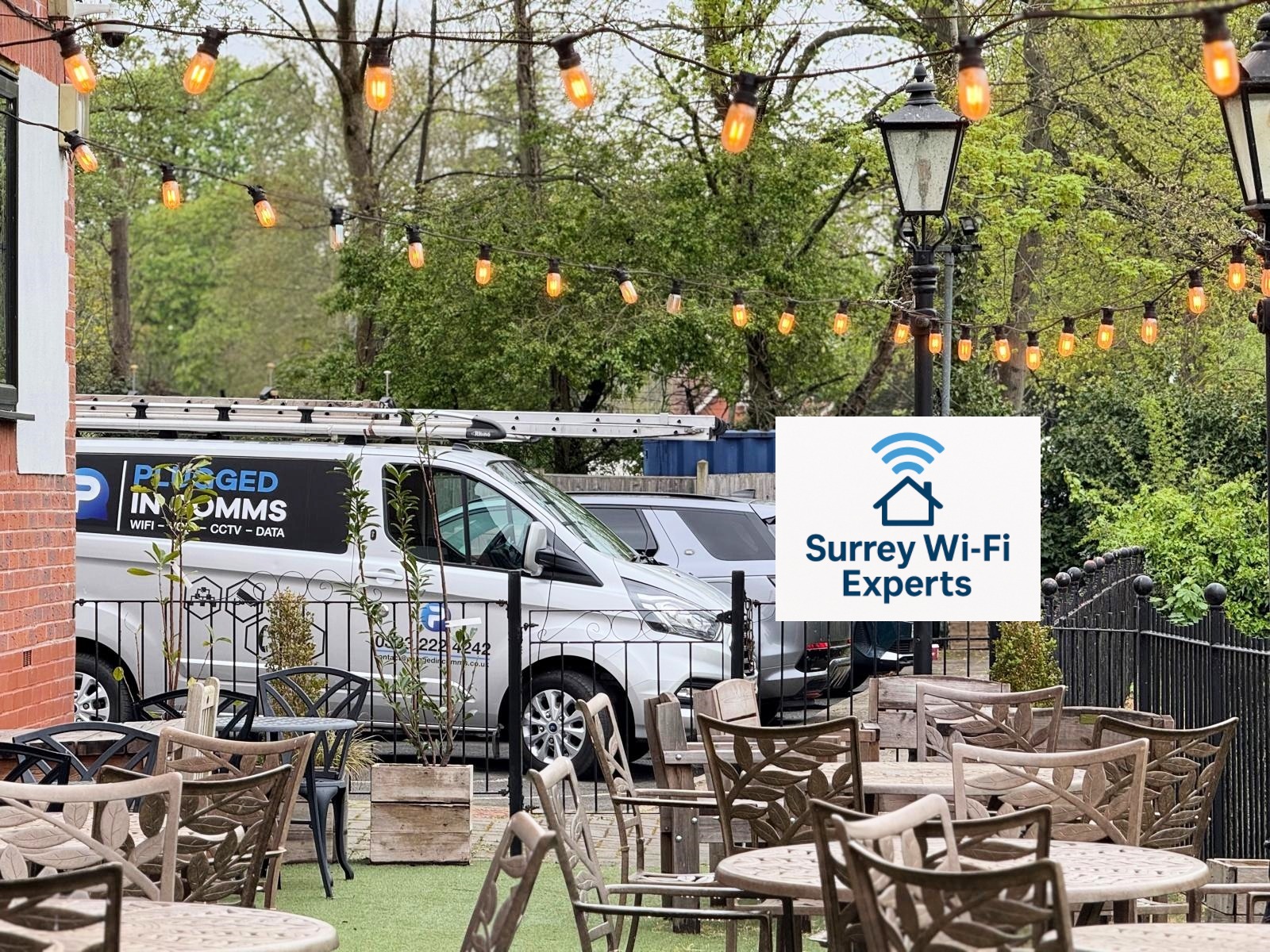 Surrey Wi-Fi & VoIP Experts van parked outside The Bridge Hotel in Chertsey, Surrey, beside the River Thames during a local service visit.