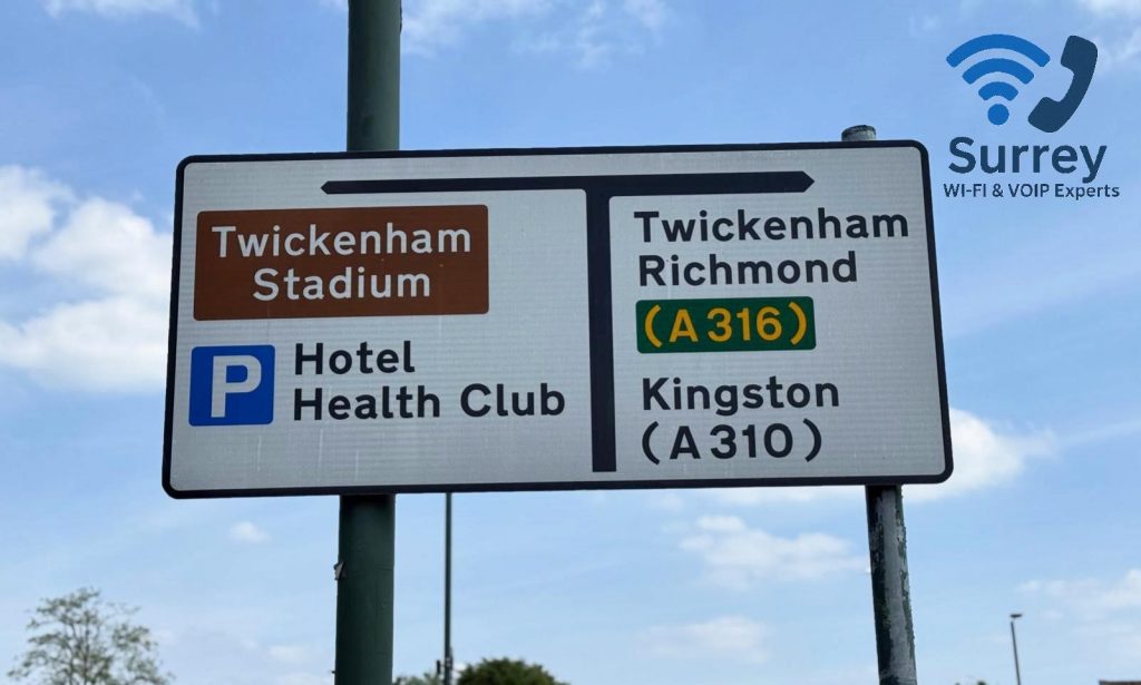 Road sign showing directions to Twickenham, with Surrey Wi-fi and VoIP Experts offering Wi-Fi system installations for both residential homes and businesses.